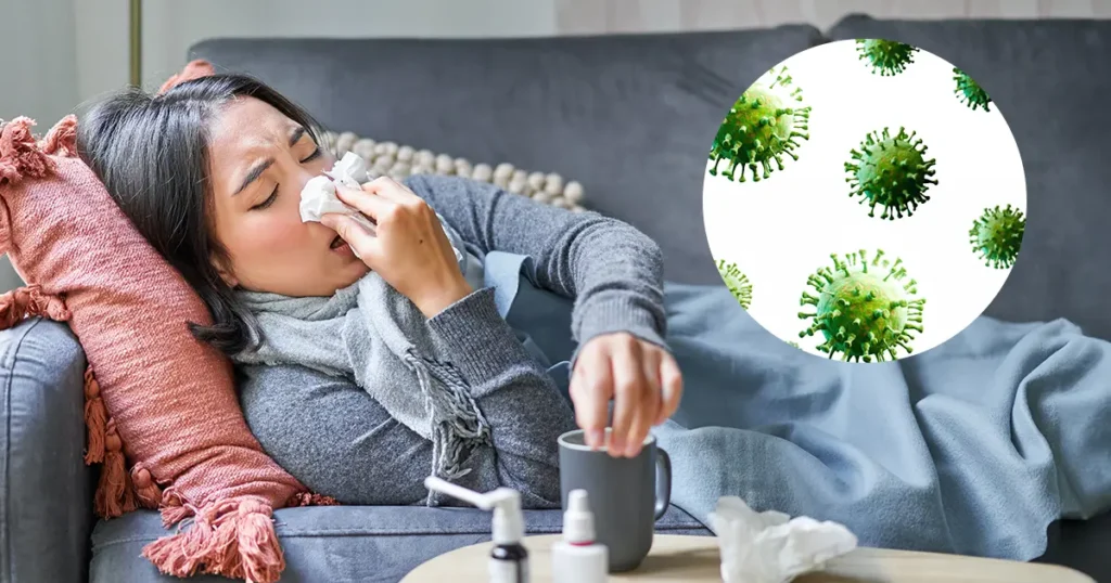 A woman suffering from influenza rests on a couch beside an illustration of the influenza virus.