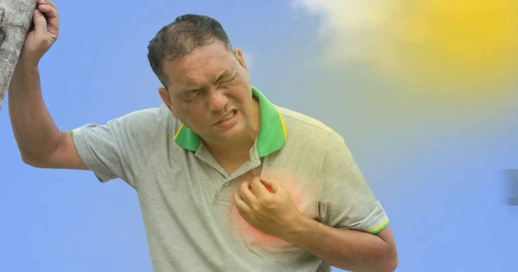 A man clutching the right side of his chest, displaying a pained expression, indicating distress