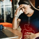 Woman holding stomach showing stress-related diarrhea symptoms