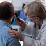 Man clutching chest in pain from anxiety episode.