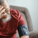 High blood pressure causing dizziness in older man at home.