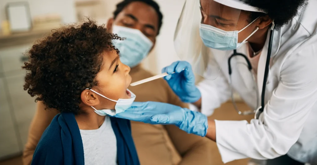 african_american_doctor_boy_sore_throat