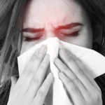 Person experiencing flu symptoms including congestion and fatigue.