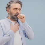 Man coughing showing bronchitis worsening into pneumonia.