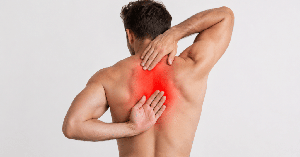 Man holding his painful middle back.