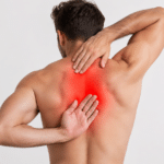 Man holding his painful middle back.