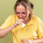 Sick woman coughing due to allergies
