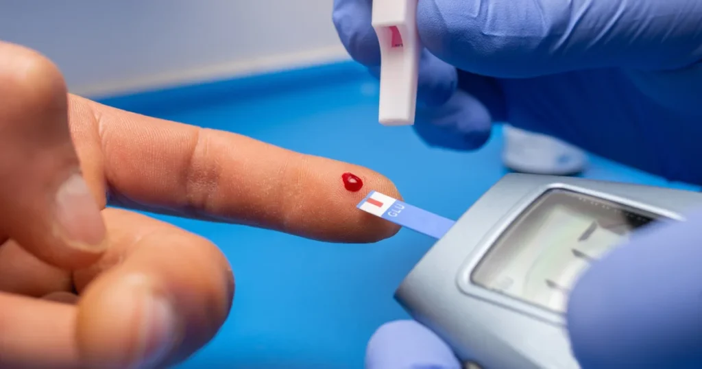 Doctor testing patient's blood sugar level