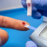 Doctor testing patient's blood sugar level